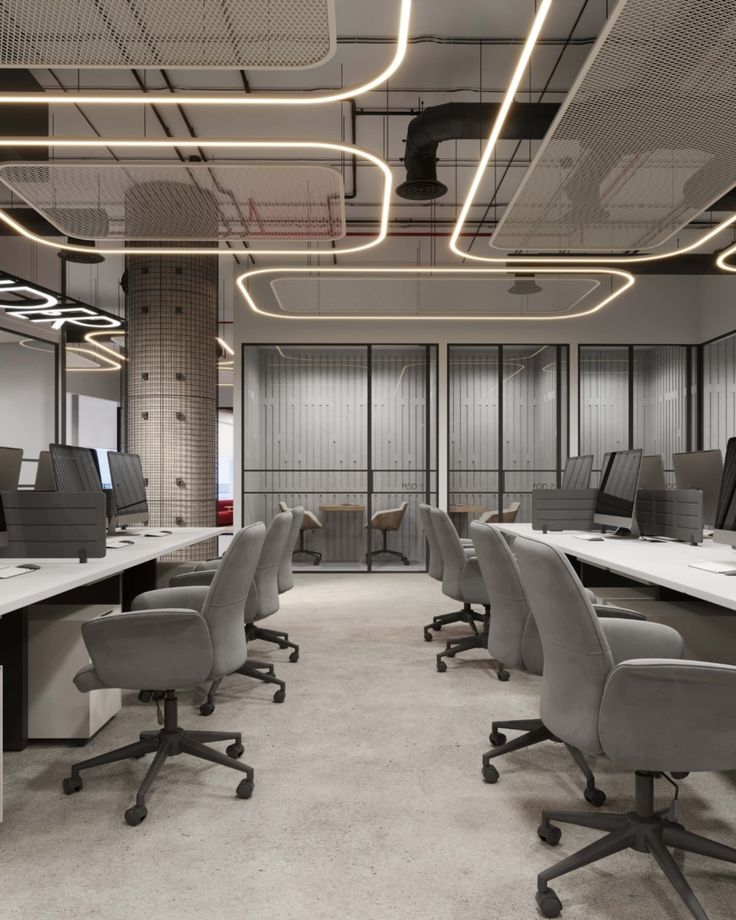 Open-plan office with suspended LED frames and mesh-wrapped column