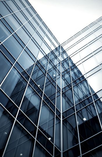 Glass tower corner facade with metal grid framing