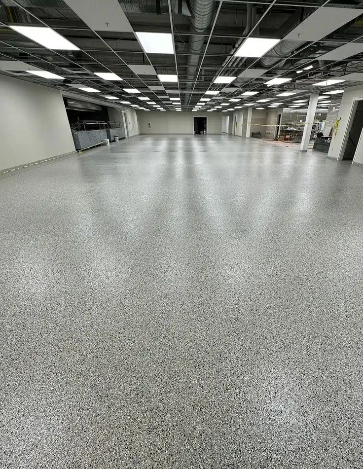 High-gloss flake-finished commercial floor reflecting ceiling lights